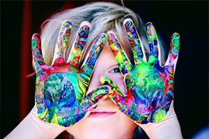 Little boy with paint on his hands